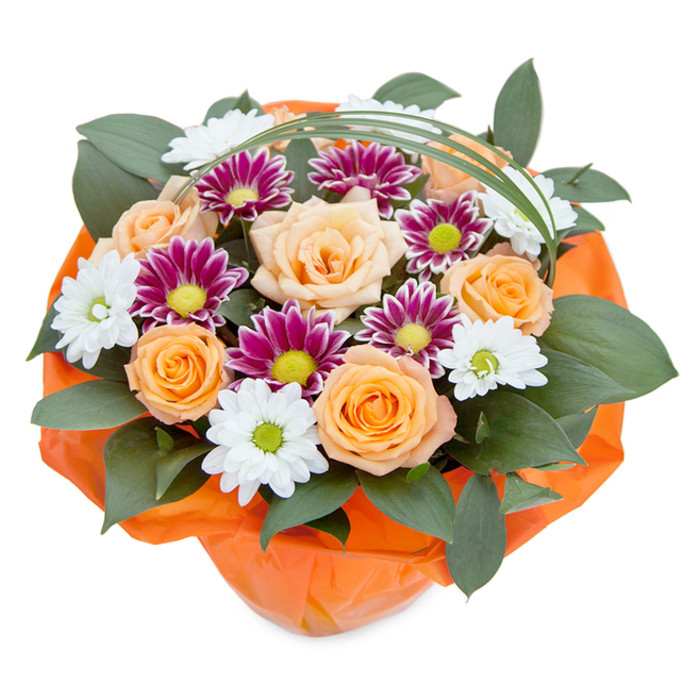 An abundant arrangement designed by a Crystal Palace florist, this bouquet is pictured from a gently elevated, top-down angle on a pure white canvas-drawing all attention to its lively craftsmanship. At the core, multiple roses unfold in warm shades from subtle peach to glowing orange, their velveteen petals opening with a classic, layered elegance. The composition is enhanced by both crisp white, daisy-like chrysanthemums and striking magenta or purple daisies, each with a brightly coloured centre that seems to echo the vibrancy of Crystal Palace's iconic transmitter tower lights. The supporting foliage is deep and glossy, possibly ruscus or similarly resilient greens, forming a grounding layer reminiscent of Bromley's shaded woodland borders. An artful swoop of bright bear grass arches above, lending lightness and enhancing the bouquet's modern visual pattern, as if mirroring the sweeping paths of Crystal Palace Park. The entire creation is wrapped in cheerful, crinkled orange cellophane, the texture and shade harmonising with the roses and imparting a sense of happy anticipation. This floral design evokes local warmth and celebration-a fitting gift for birthdays, anniversaries, or spontaneous acts of kindness across SE19. Its carefully balanced palette, artful arrangement, and subtle nods to local landmarks invite both admiration and appreciation for the unique energy of Crystal Palace.