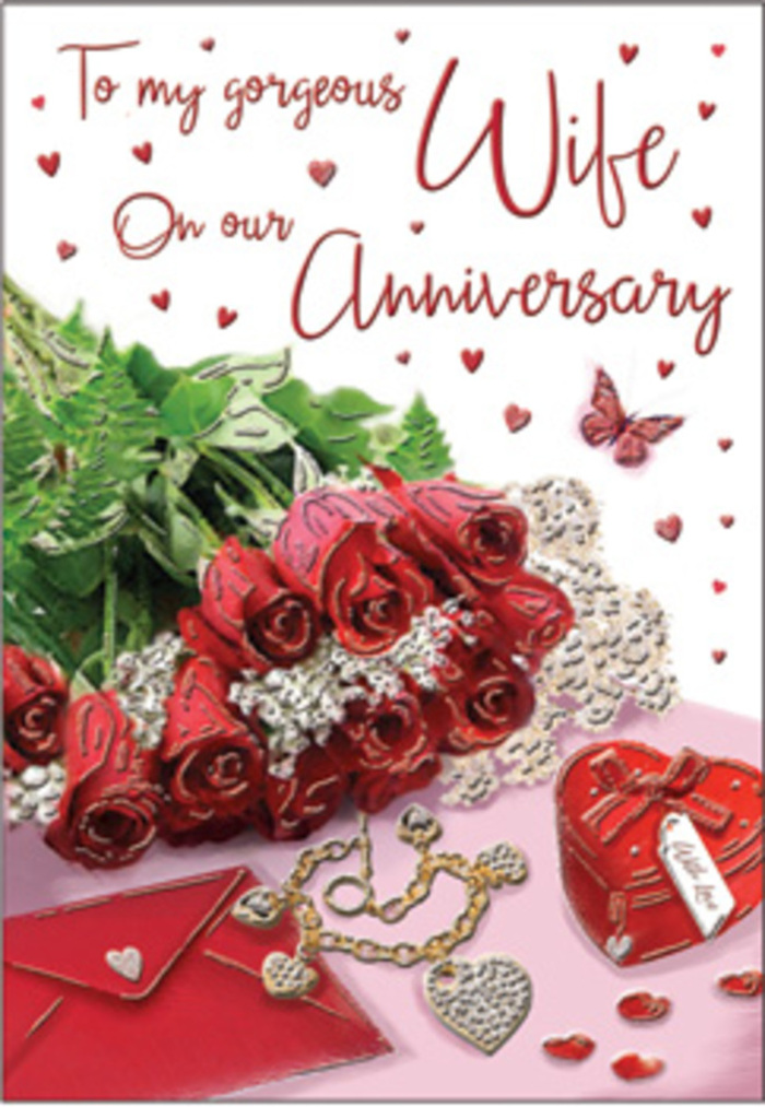 The image presents a carefully curated anniversary card composition, as if styled in a cosy Crystal Palace living room where natural light drifts softly through the windows. In the centre, a small bouquet of red roses commands attention, each blossom plump and fully open, with velvety petals sculpted into elegant spirals of rich crimson. The roses nestle into a cushion of fresh green foliage, whose glossy leaves offer contrast and depth, evoking the sense of a freshly arranged posy collected from a flower stall near Crystal Palace station. Beside this floral focal point lies an envelope and partially visible card, the edges of the paper crisp and clean, with graceful handwritten or scripted text that hints at a loving anniversary message. A piece of jewellery-delicate yet eye-catching-rests nearby, its metallic sheen catching the soft ambient light, adding a sense of special occasion and quiet luxury. Close to it, a heart-shaped keepsake box stands as a tangible symbol of cherished memories and small treasures carefully saved over the years. Scattered across the scene are tiny heart decorations and a single butterfly motif, bringing movement and whimsy into the otherwise serene tableau. The surface beneath appears smooth and subtly reflective, causing a gentle shimmer that complements the warm, romantic colour palette. The lighting, neither too bright nor too dim, creates tender highlights on the flowers, card, and jewellery, much like the soft glow of an evening sky over the Crystal Palace skyline. Altogether, the composition communicates intimacy, longevity, and gratitude, making this card an evocative way to honour yet another chapter in a shared love story.