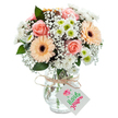 Bathed in gentle white light, this elegant bouquet sits ready to bring the charm of Crystal Palace's creative spirit into any setting. At its centre, peach and pale-pink roses unfurl their velvety layers, offering a romantic, classic focus. Two playful peach-orange gerbera daisies, wide-eyed with rich brown centres, offer a cheerful complement, much like the upbeat atmosphere of local artisan markets. Wispy sprays of baby's breath drift between blooms, lending the arrangement an airy softness reminiscent of Crystal Palace's open green spaces at sunrise. Petite clusters of bright white chrysanthemums, each with crisp lime centres, add dimensional contrast and a zesty pop. Strategically placed sprigs of eucalyptus introduce fresh greenery and subtle scent. Set in a clear, subtly grooved glass vase, the bouquet's stems are visible, and the whole is finished with a rustic tie and a clean white tag for a personal note. This piece is perfect for birthdays, thank you messages, or simply to share a breath of Crystal Palace's unique blend of tradition, artistry, and warmth.